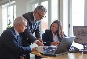 Concentrated colleagues watching statistic charts and talking